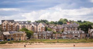 A view of North Berwick, Lothian, taken from the sea and shows the beach and grand family homes on the shoreline.